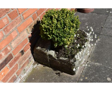 A VINTAGE SANDSTONE PUMP TROUGH width 54cm depth 57cm height 30cm at highest point with soil and planting Condition some loss