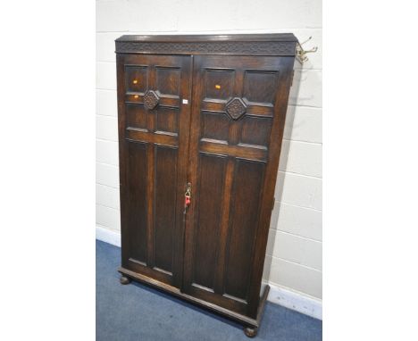 AN EARLY 20TH CENTURY MAPLE AND CO OF LONDON, OAK TWO DOOR HALL ROBE/CUPBOARD, enclosing a shelf fitted with a single shelf a