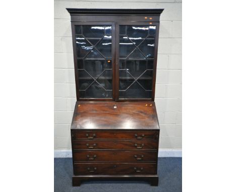 A GEORGIAN MAHOGANY BUREAU BOOKCASE, the double astragal glazed doors, enclosing three adjustable shelves, over a full front 