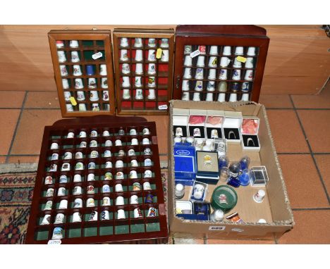 A BOX AND FOUR TRAYS OF THIMBLES, over one hundred and fifty mainly ceramics thimbles by makers including Coalport, Royal Wor