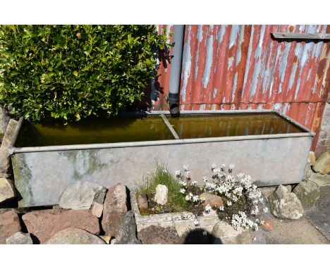 A LARGE GALVANIZED METAL WATER TROUGH width 186cm depth 49cm height 39cm ( this lot is not sold on site, viewing for off site