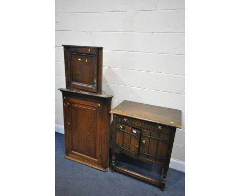 A GEORGIAN OAK FIELDED PANEL HANGING CORNER CUPBOARD, a smaller oak hanging cupboard, and an oak two door and single drawer c