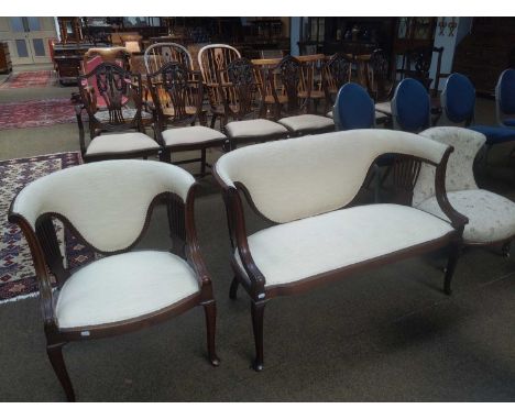 An Edwardian Mahogany Parlour Sofa with Matching Chair, with cream upholstery; together with a nursing chair (3)