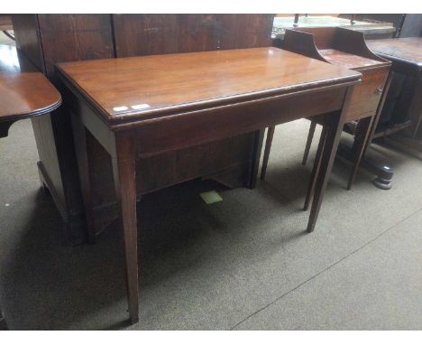 A George III Mahogany Fold Over Table, together with a pair of Victorian oak hall chairs and an Edwardian lamp table fitted w