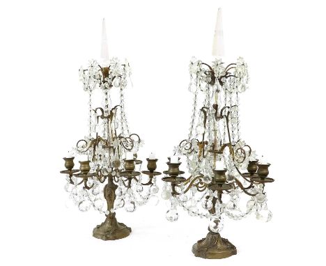 A Pair of French Gilt Metal and Glass Six-Light Candelabra, 19th century, with faceted finials, the baluster stem with scroll