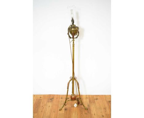 A 20th Century brass standard lamp, converted originally from an oil lamp, the single brass column, raised on scrolled tripod