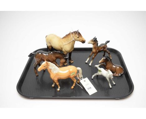 A selection of Beswick equestrian figures, including: Highland Pony; Lying Foal; Palamino horse; and others. (6)