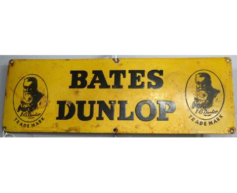 A Bates Dunlop enamel advertising sign, of rectangular form, inscribed ‘Bates Dunlop’ within Dunlop portrait logos, 20.5 x 61