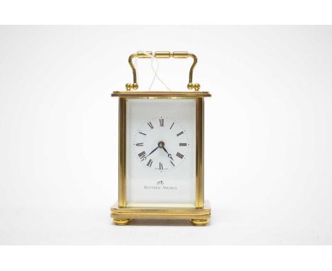 A Matthew Norman brass cased carriage clock, white enamel Roman dial, platform lever escapement, 14.5cms high (including hand