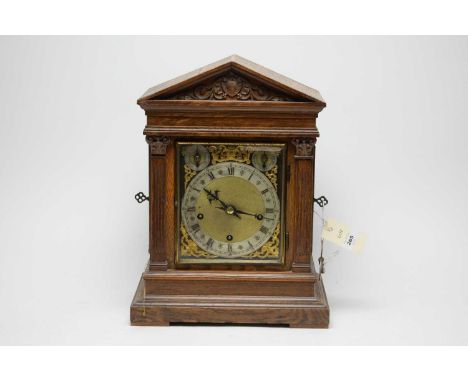 A 19th Century oak bracket clock, in carved architectural case, 41cms high.