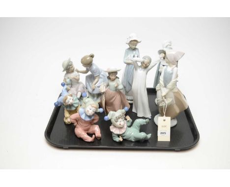 A collection of Nao decorative ceramic figures, including: three little boy clown figures; figure group of two children; and 