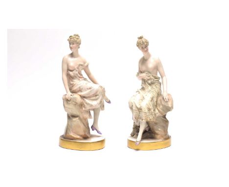 A pair of late 19th century German porcelain figures of semi-clad female dancers, each picked out in flesh tones and pale col