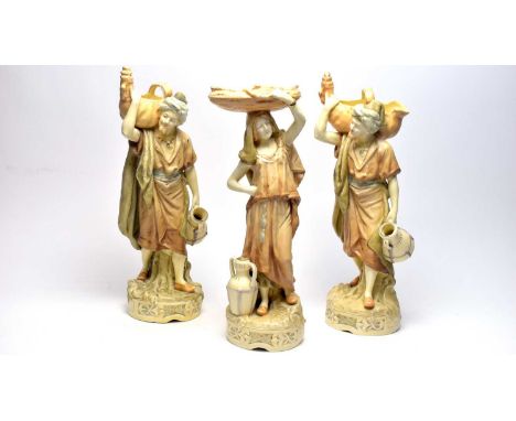 A pair of Royal Dux porcelain figures of Eastern street vendors, depicted carrying amphora and large baskets, 40cms; and a si