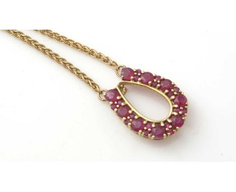 A horseshoe pattern ruby pendant in 9ct yellow mount on twist link chain, 7.3g gross.
