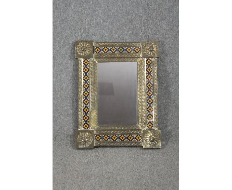 A metal framed mirror set with small glazed tiles. H.67 W.52cm. 