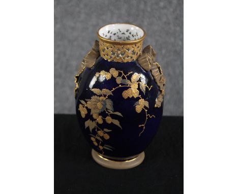 Royal Worcester. A china vase with a deep blue glaze and ribbon and floral decoration. Early to mid twentieth century. H.20cm