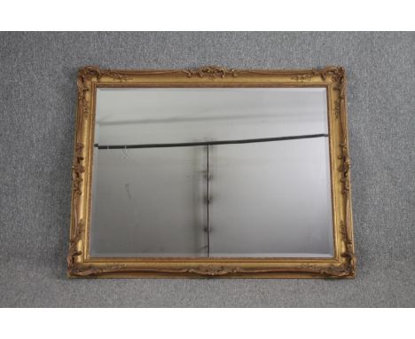 Two wall mirrors, gilt foliate with rectangular bevelled plate and a vintage circular mirror. H.92 W.117cm. 