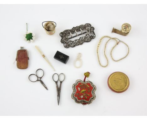 A late Victorian silver buckle, Textile and sewing related items including a bone tape measure, 2 pin cushions, mother of pea