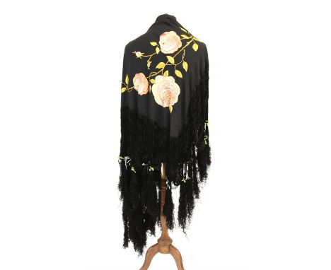 Two early 20th century black silk large fringed shawls together with machine black lace stole and black net fabric remnant Co