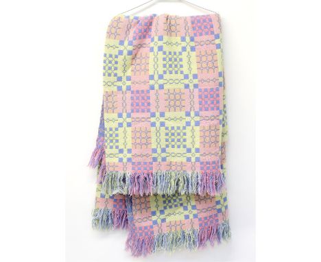 Two matching Welsh blankets woven in pastel colours, lavender, pink, yellow and white with geometric designs.220cm x 150cm ap