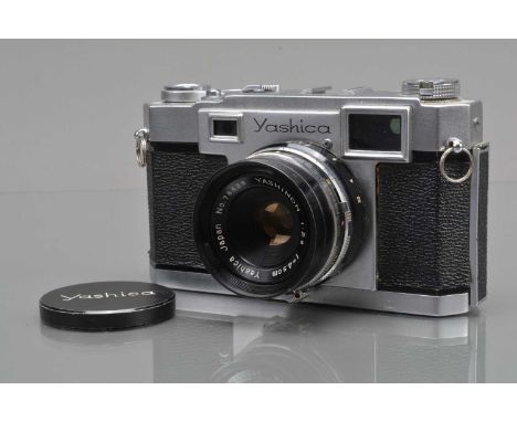 A Yashica 35 Rangefinder Camera, shutter sluggish in slow speeds, rangefinder working, self timer working, body G, two tiny d