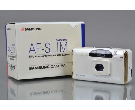 A Samsung Special Edition AF-Slim Quartz Date Compact Camera, white with gold coloured edges/button, shutter working, flash w