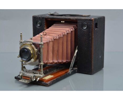 An Eastmam Kodak Cartridge Kodak Folding Bed Camera, body G, back catch stuck, bellows F, shutter working, with Bausch & Lomb