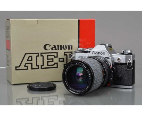 A Canon AE-1 SLR Camera, chrome, shutter working, meter responsive, self timer working, body G-VG, with Sigma 28-84mm f/3.5-4