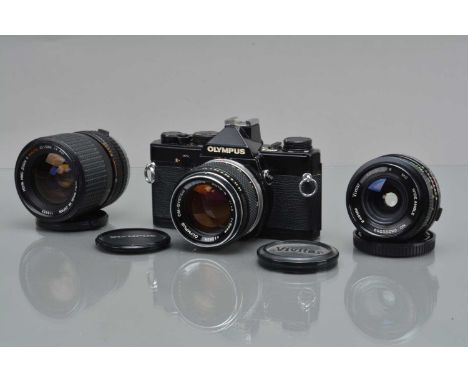 An Olympus OM-1 SLR Camera,  black, shutter working, meter unresponsive, self timer working, some foam debris in finder, body