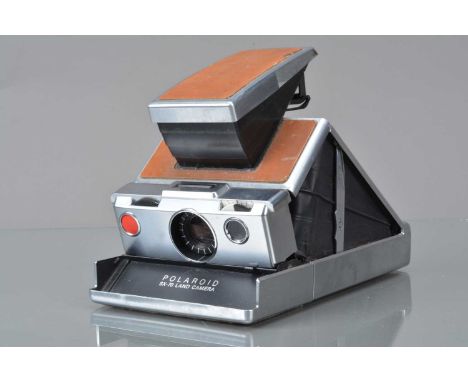 A Polaroid SX-70 Land Camera, tan, untested, body G, elements F, fungus spots, with manual