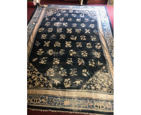 A large vintage Chinese woollen carpet. L.520 W.380cm. (Patches of wear as seen). 