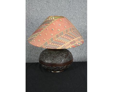 A carved hardwood lamp. Decorated with a tribal relief pattern. H.45 cm. 