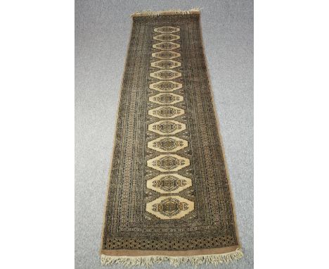 Runner, Bokhara with repeating gul motifs in flowerhead multiple borders. L.310 W.85cm. 