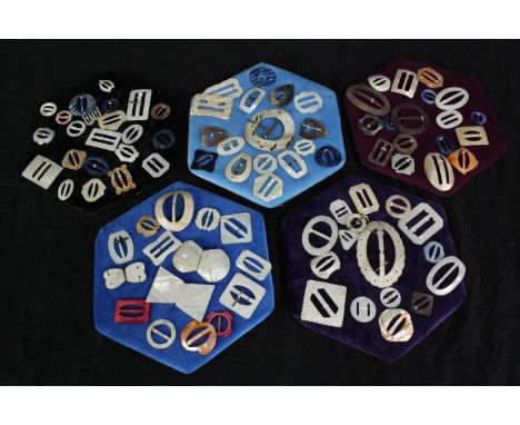 Five cushioned boards with a collection of 19th and 20th century buckles, carved from mother of pearl and shell with differen