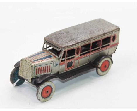 "Excursion Motor Car", tinplate and clockwork comprising Pale gold with red and blue trim, Five figures inside, black base wi