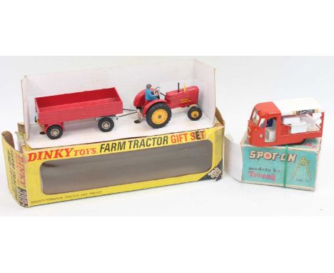 A group of two models as follows: 399 Dinky Farm tractor and trailer in near condition in a poor window box which needs repai