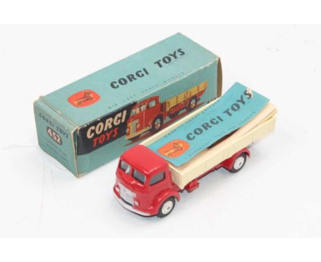 A Corgi Toys No. 452, five-ton dropside lorry with red cab and chassis with cream back and flat spun hubs (2 chips to cab roo