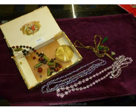 A quantity of beads, crystal, north African, shell and powder compact together with wooden prayer beads