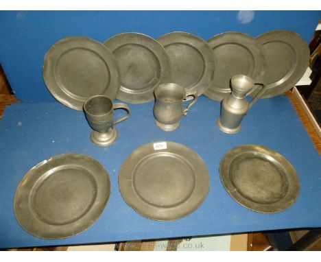 A quantity of antique and vintage Pewter including eight dinner plates, two tankards and a measure.