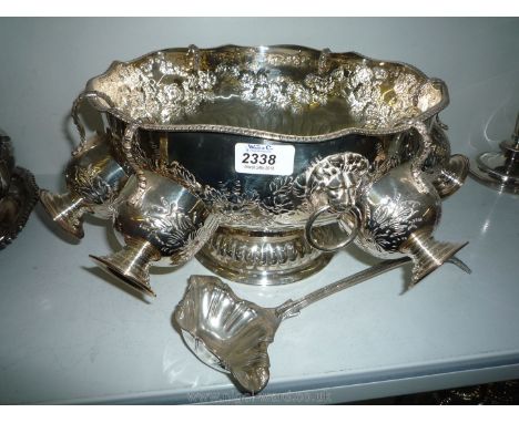 An embossed Punch Bowl having two lion handles and with six cups and a ladle