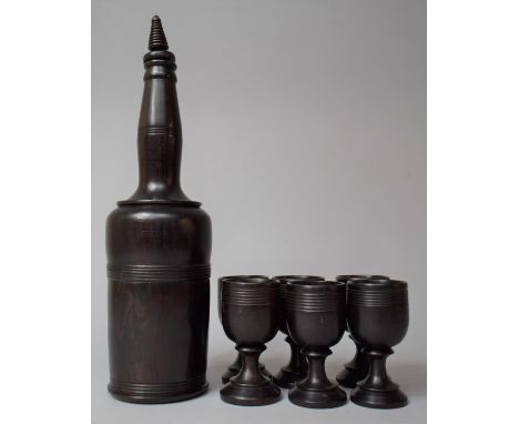 A Lignum Vitae Wooden Decanter with Six Small Goblets 
