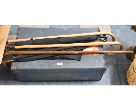 A Vintage Suitcase Together with Walking Sticks and Umbrellas 