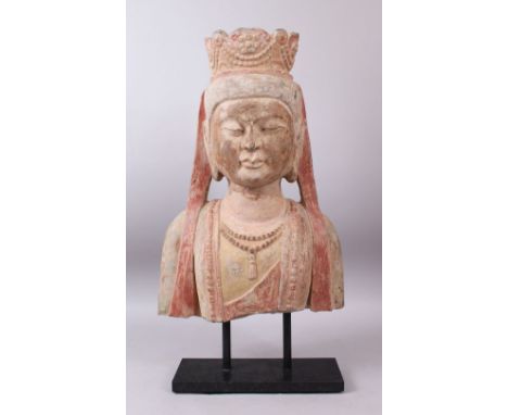 A 19TH / 20TH CENTURY SANDSTONE BUST OF BUDDHA wearing a headdress, with polychrome decoration, on later stand. 63cms high.