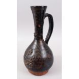 A 19TH CENTURY OTTOMAN TURKISH CANAKKALE BROWN GLAZED JUG, 33cm high.