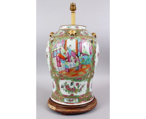 A 19TH CENTURY CHINESE CANTON FAMILLE ROSE PORCELAIN TEMPLE JAR / VASE / LAMP, the body of the lamp decorated with panels dep