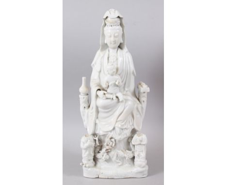 A GOOD CHINESE KANGXI PERIOD BLANC DE CHINE PORCELAIN FIGURE OF GUANYIN AS MADONNA WITH CHILD, the figure stood on a formed b