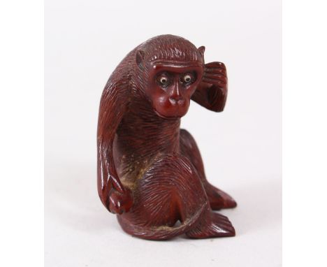 A GOOD JAPANESE MEIJI PERIOD CARVED WOOD NETSUKE OF A MONKEY, the monkey sat with his hand by his ear, eyes inlaid, 5cm high.