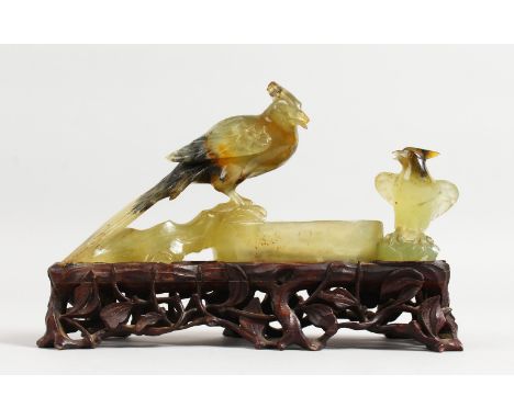 A GOOD 19TH CENTURY CHINESE CARVED JADE GROUP OF TWO BIRDS on a pierced wooden stand. 6ins long.
