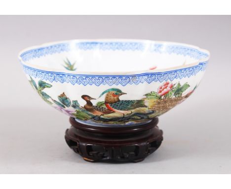 A GOOD CHINESE 20TH CENTURY EGGSHELL PORCELAIN BOWL, decorated with scenes of lotus flowers and blue dragons, the base with a