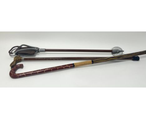 A collection of walking sticks comprising, a brown walking stick with handles and extendable brown leather seat to top (h. 86